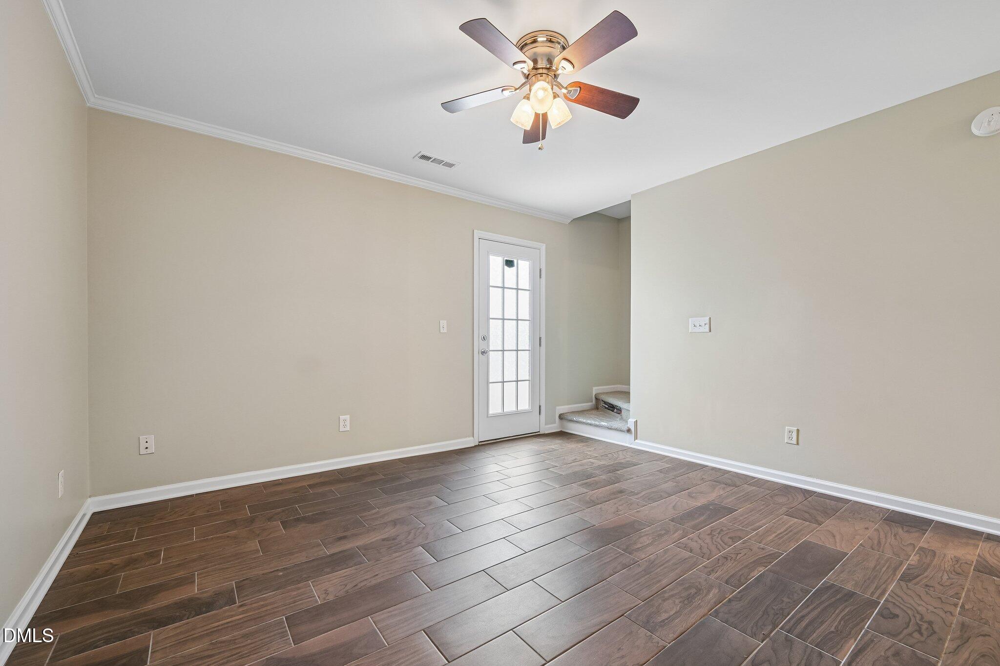 278 South Raleigh Street Angier, NC 27501 - Photo 14 of 35 an empty room with wooden floor and windows
