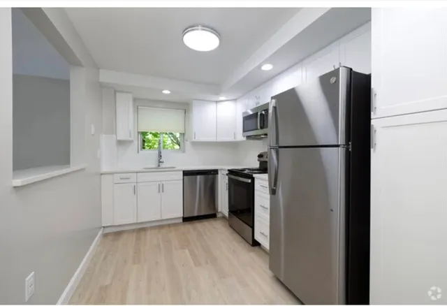 a kitchen with a refrigerator a sink and dishwasher