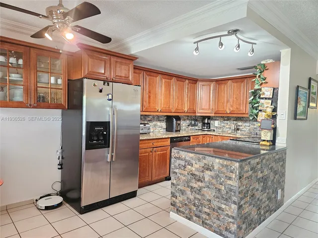 a kitchen with stainless steel appliances granite countertop a refrigerator a sink and dishwasher