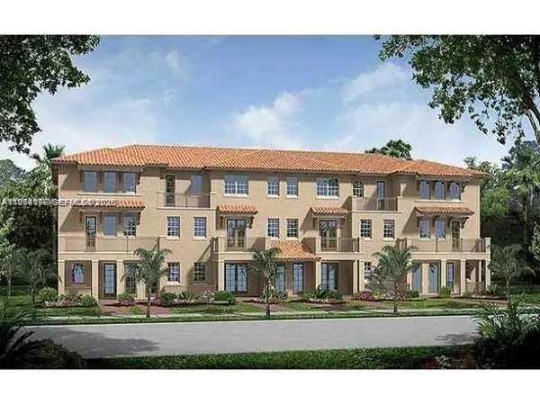 a front view of a residential apartment building with a yard
