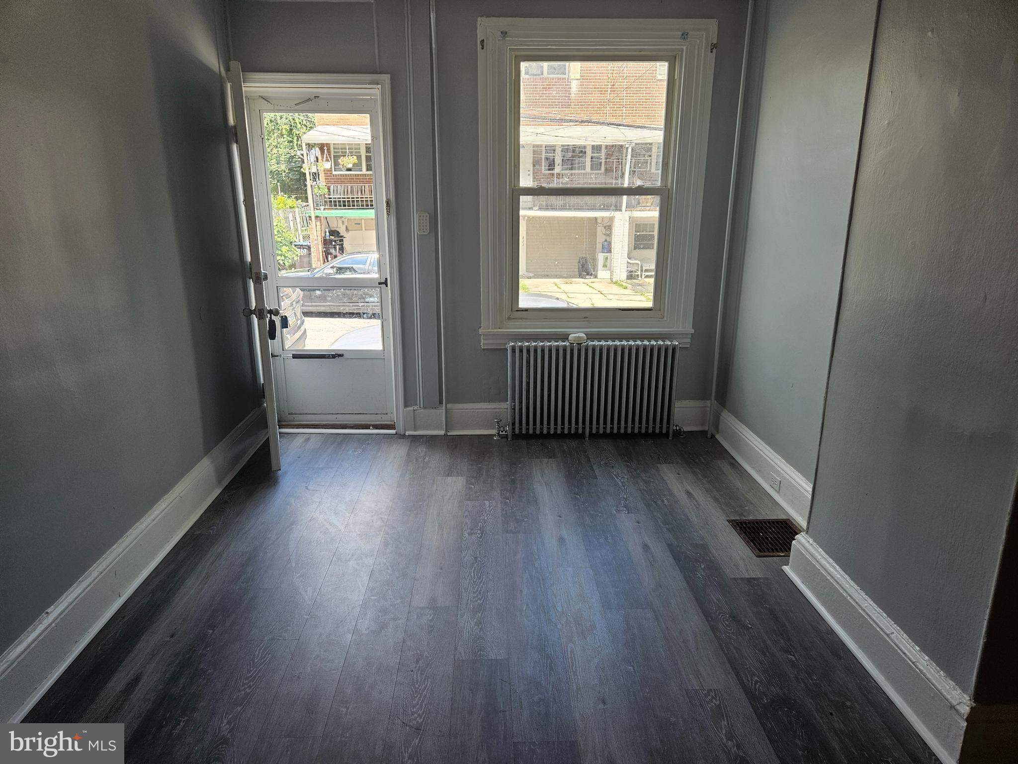 812 Kohn Street Norristown, PA 19401 - Photo 2 of 9 an empty room with wooden floor and windows