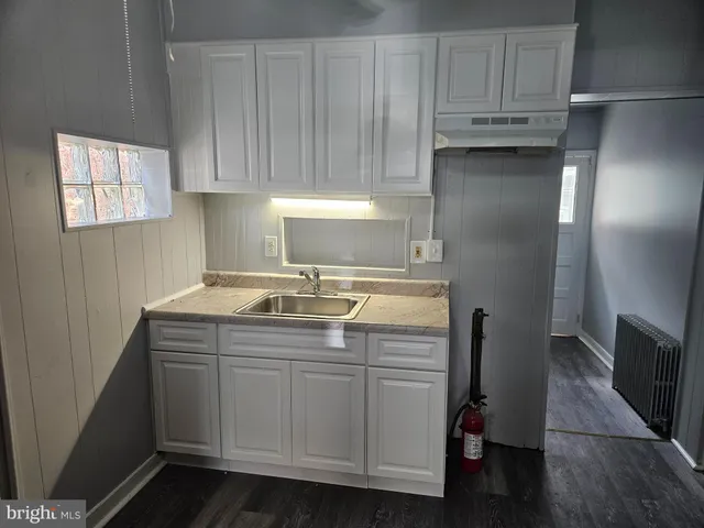 a kitchen with stainless steel appliances granite countertop a sink and a refrigerator