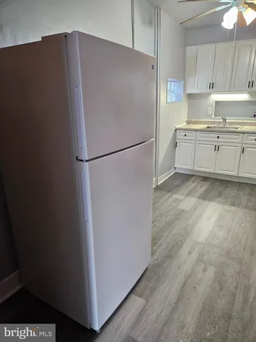 a white refrigerator freezer sitting in a kitchen