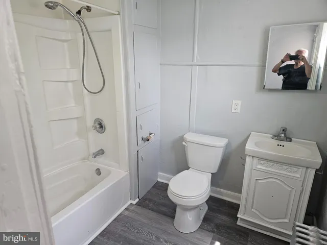 a bathroom with a toilet sink and shower