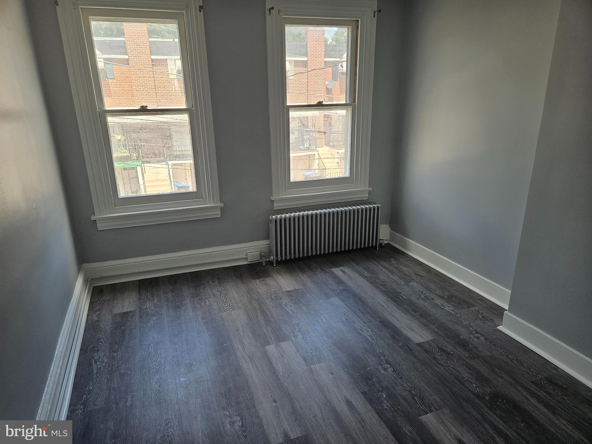 812 Kohn Street Norristown, PA 19401 - Photo 7 of 9 an empty room with wooden floor and windows