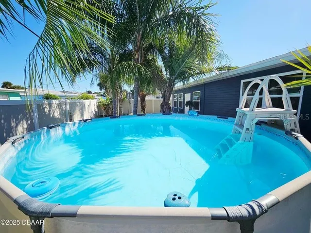 a view of a backyard with swimming pool