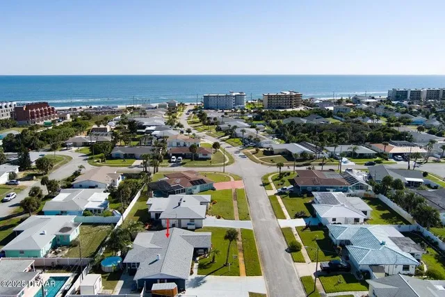 an aerial view of houses with outdoor space