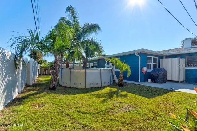 a view of a house with backyard and a swimming pool