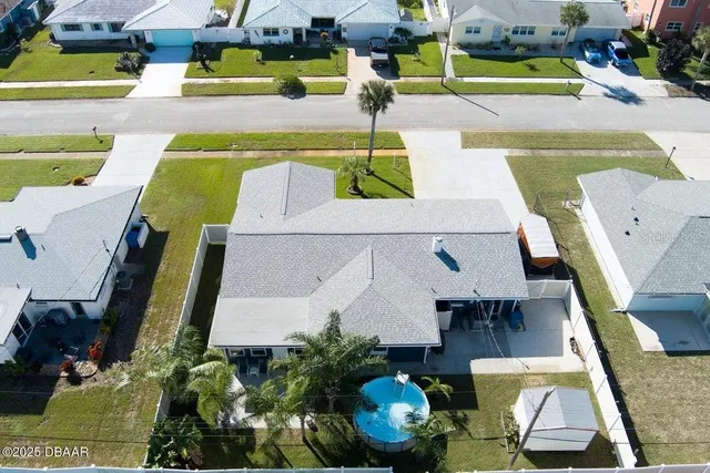 an aerial view of a swimming pool with a patio