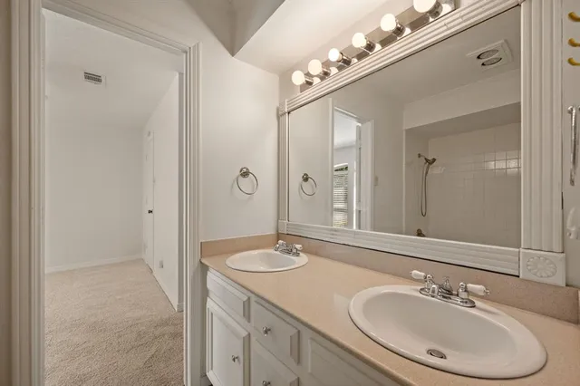 a bathroom with a sink double vanity and a mirror