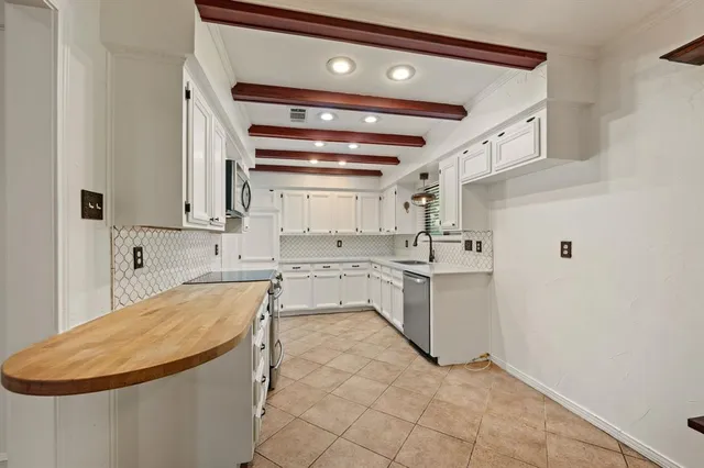 a kitchen with a sink cabinets and appliances