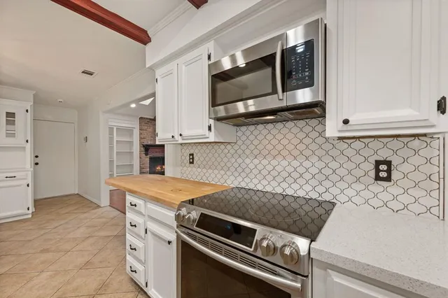 a kitchen with stainless steel appliances granite countertop a stove and a microwave