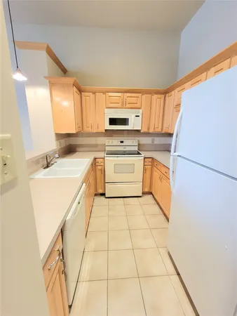 a kitchen with a stove a sink and a refrigerator