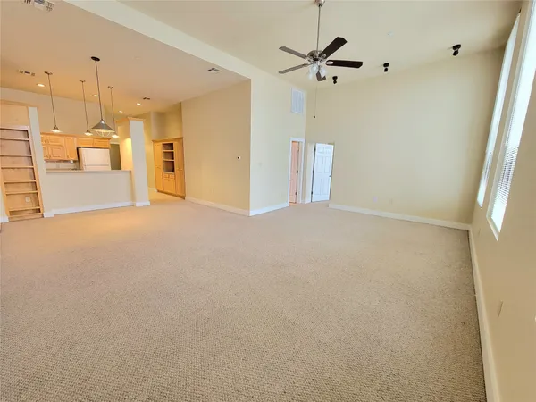 a view of a kitchen with a sink and a refrigerator