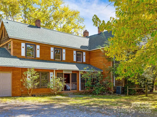 a view of yard with swimming pool and trees