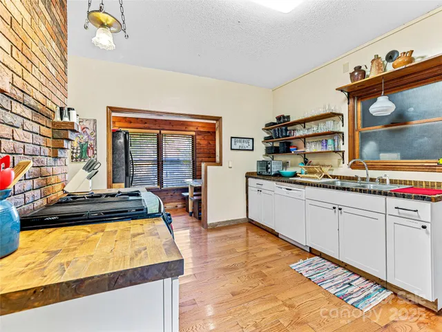 a kitchen with stainless steel appliances granite countertop a stove and a refrigerator