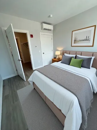 a bedroom with a bed and a rug