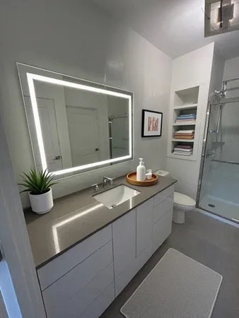 a bathroom with a double vanity sink and mirror