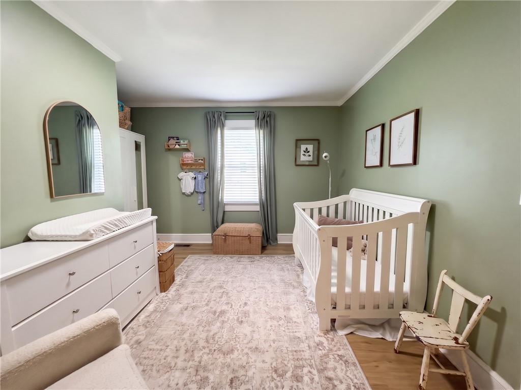 710 O Neal Street Belton, SC 29627 - Photo 16 of 18 Sweet dreams await in this charming nursery, featuring soft tones and hardwood flooring.