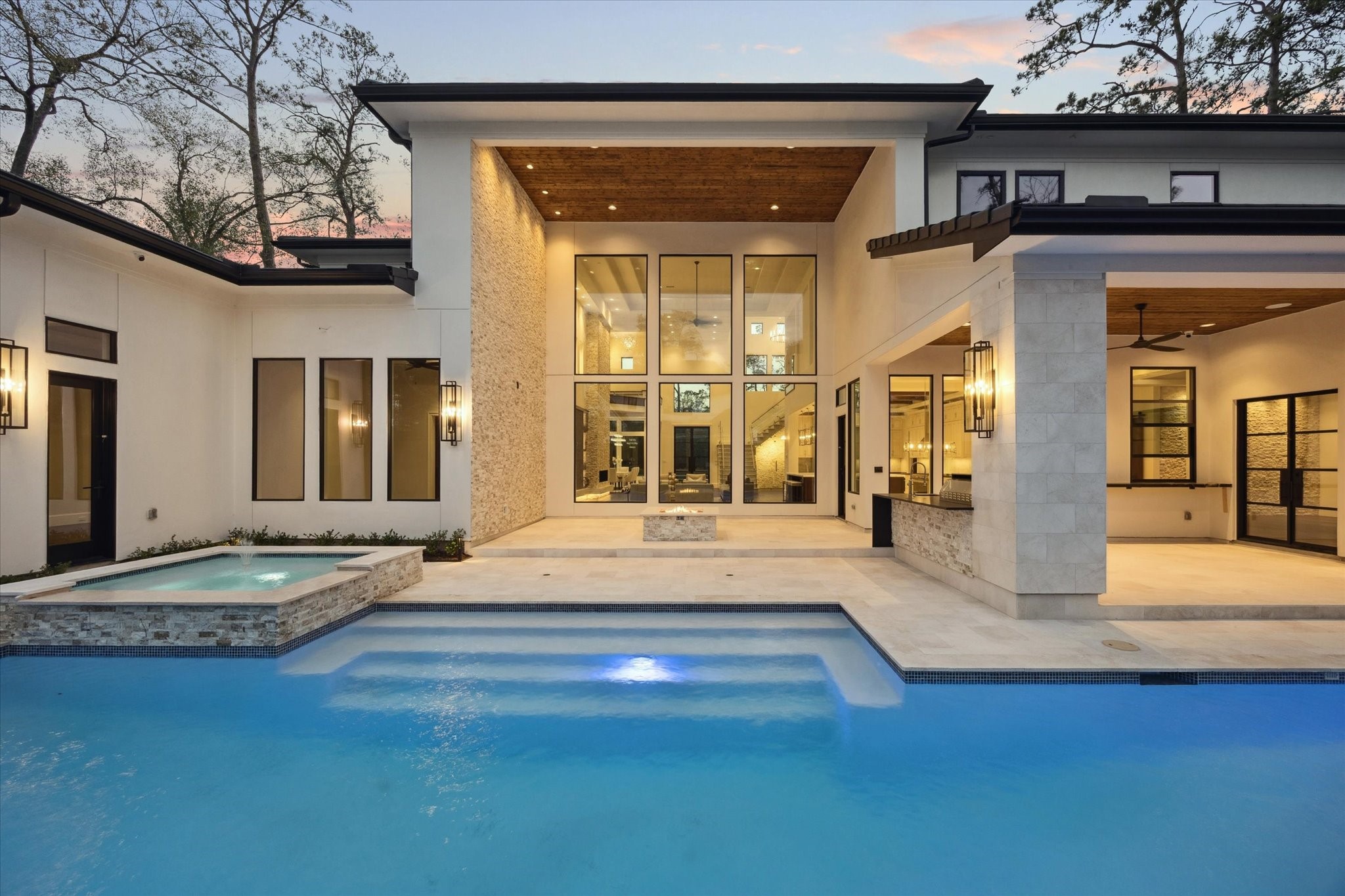 318 Knipp Road Houston, TX 77024 - Photo 27 of 32 Walls of glass seamlessly connect the indoor living spaces to the resort-style pool, creating a stunning indoor-outdoor living experience filled with natural light.