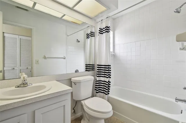 a bathroom with a sink toilet a shower and a mirror