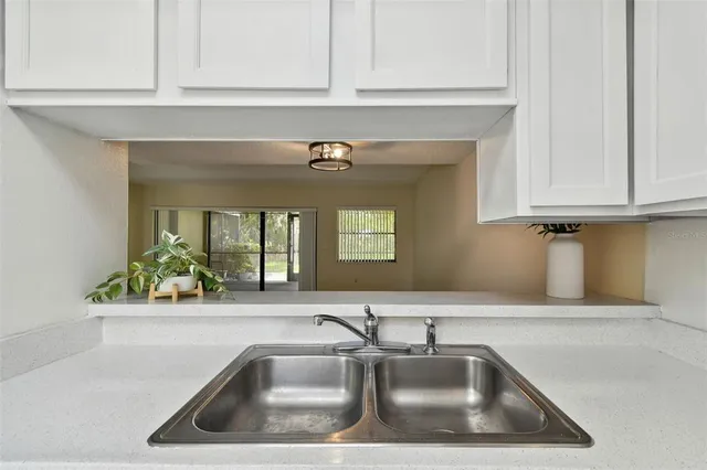a kitchen with a sink and cabinets