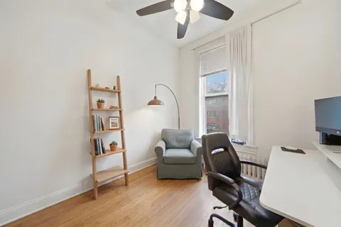 a livingroom with workspace and a couch