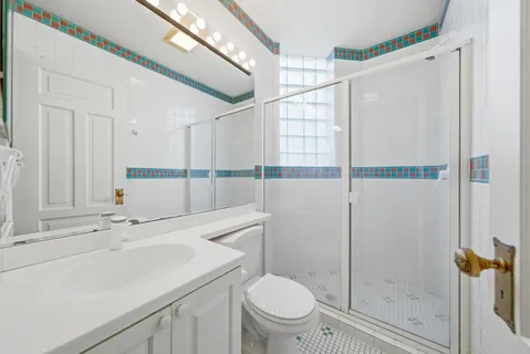 a bathroom with a sink toilet and shower