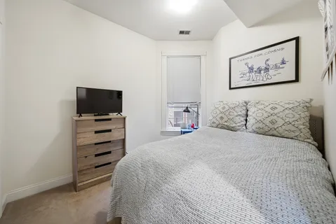 a bedroom with a bed and a television