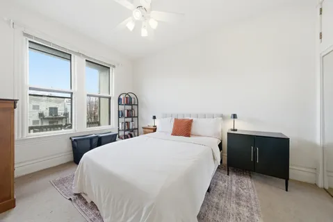 a bedroom with a large bed and a window