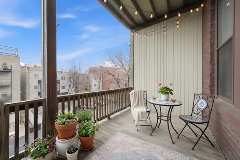 a view of a chairs and table in the balcony