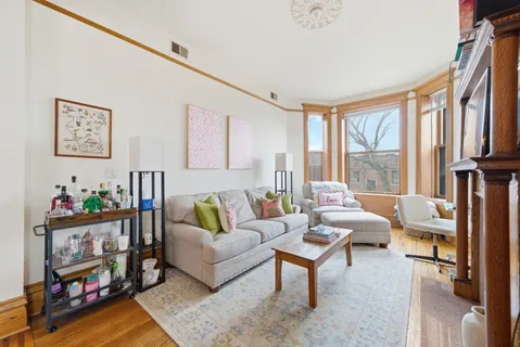a living room with furniture and a floor to ceiling window