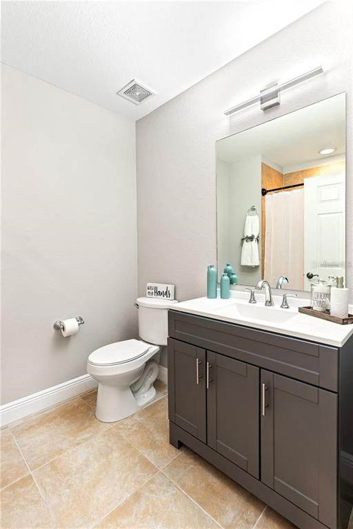 1121 Riverscape Street Bradenton, FL 34208 - Photo 23 of 74 a bathroom with a toilet sink and mirror
