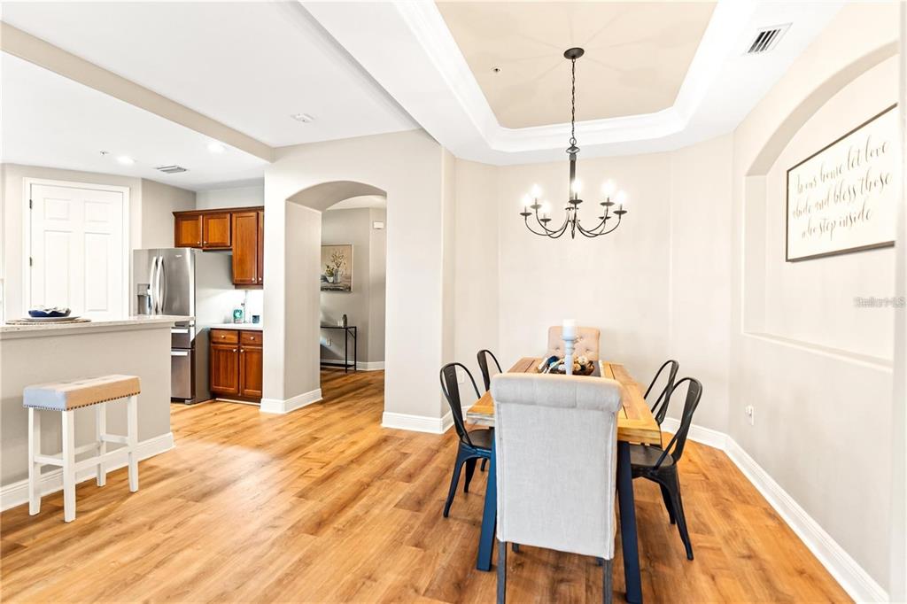1121 Riverscape Street Bradenton, FL 34208 - Photo 49 of 74 a dining room with furniture a chandelier and wooden floor