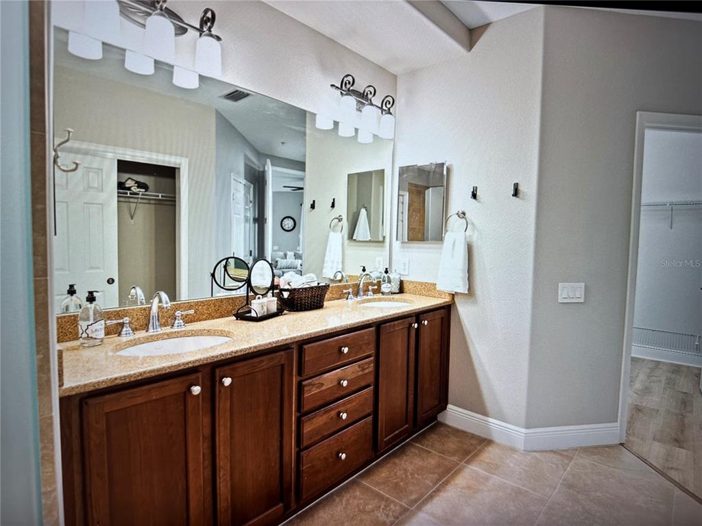 1121 Riverscape Street Bradenton, FL 34208 - Photo 5 of 74 a bathroom with a double vanity sink and a mirror