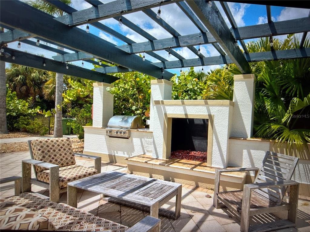 1121 Riverscape Street Bradenton, FL 34208 - Photo 10 of 74 a view of a patio with a table chairs and a grill
