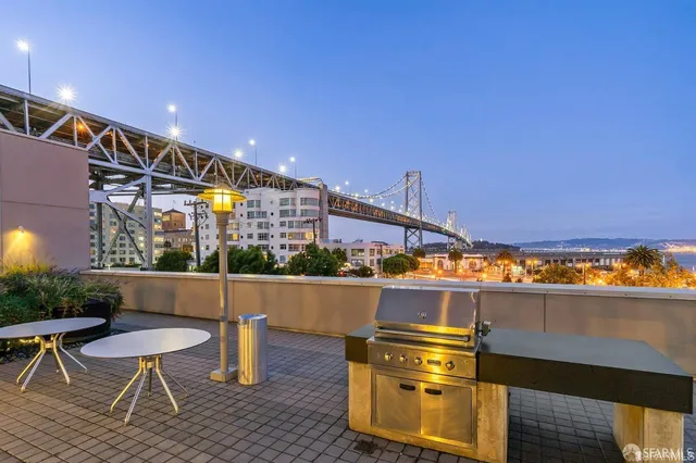 a view of swimming pool with a lawn chairs under an umbrella