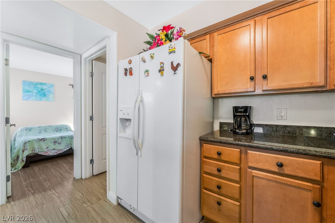 3145 East Flamingo Road, Unit 1092 Las Vegas, NV 89121 - Photo 12 of 33 Granite counters and light wood cabinetry define this compact, functional kitchen space.