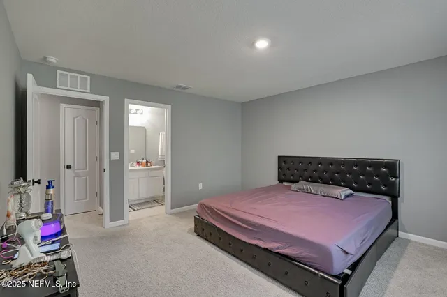 a bathroom with a sink a toilet a mirror and shower curtain