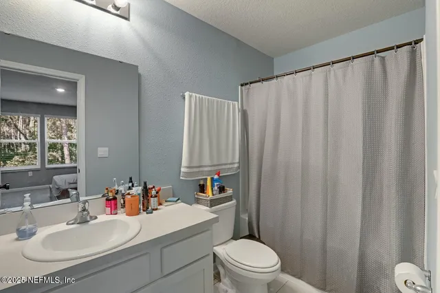 a bedroom with bed and a window