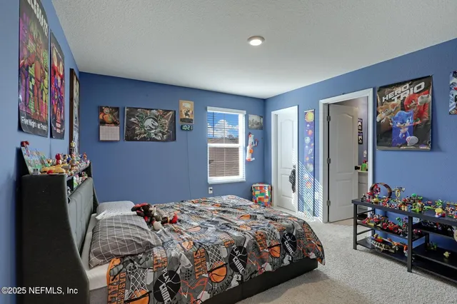 a bedroom with a bed and a bookshelf