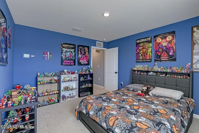 a bedroom with bed and furniture