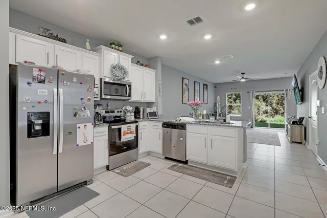 a kitchen with cabinets and stainless steel appliances