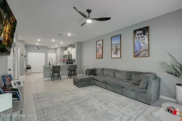 a living room with furniture and kitchen view