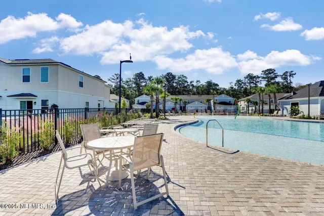 a view of a lake with a table and chairs