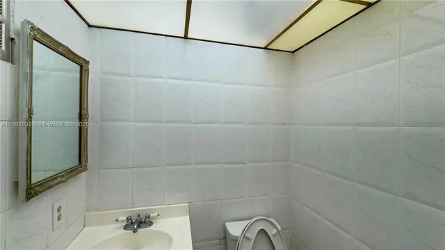 a view of a kitchen with a refrigerator a fireplace and a sink