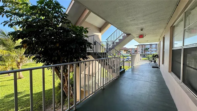 a kitchen with kitchen island granite countertop a stove a sink and a refrigerator