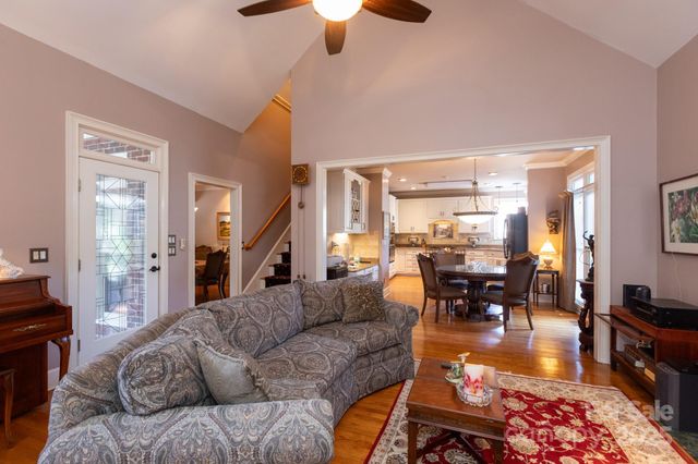 a living room with furniture and a dining table