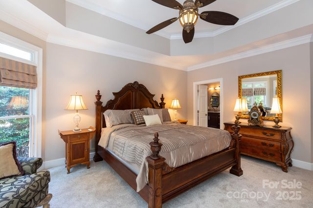 a bedroom with a bed and ceiling fan