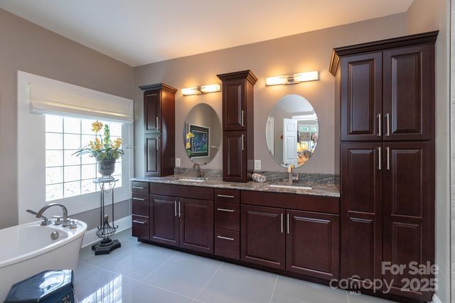 a spacious bathroom with a granite countertop sink and a mirror